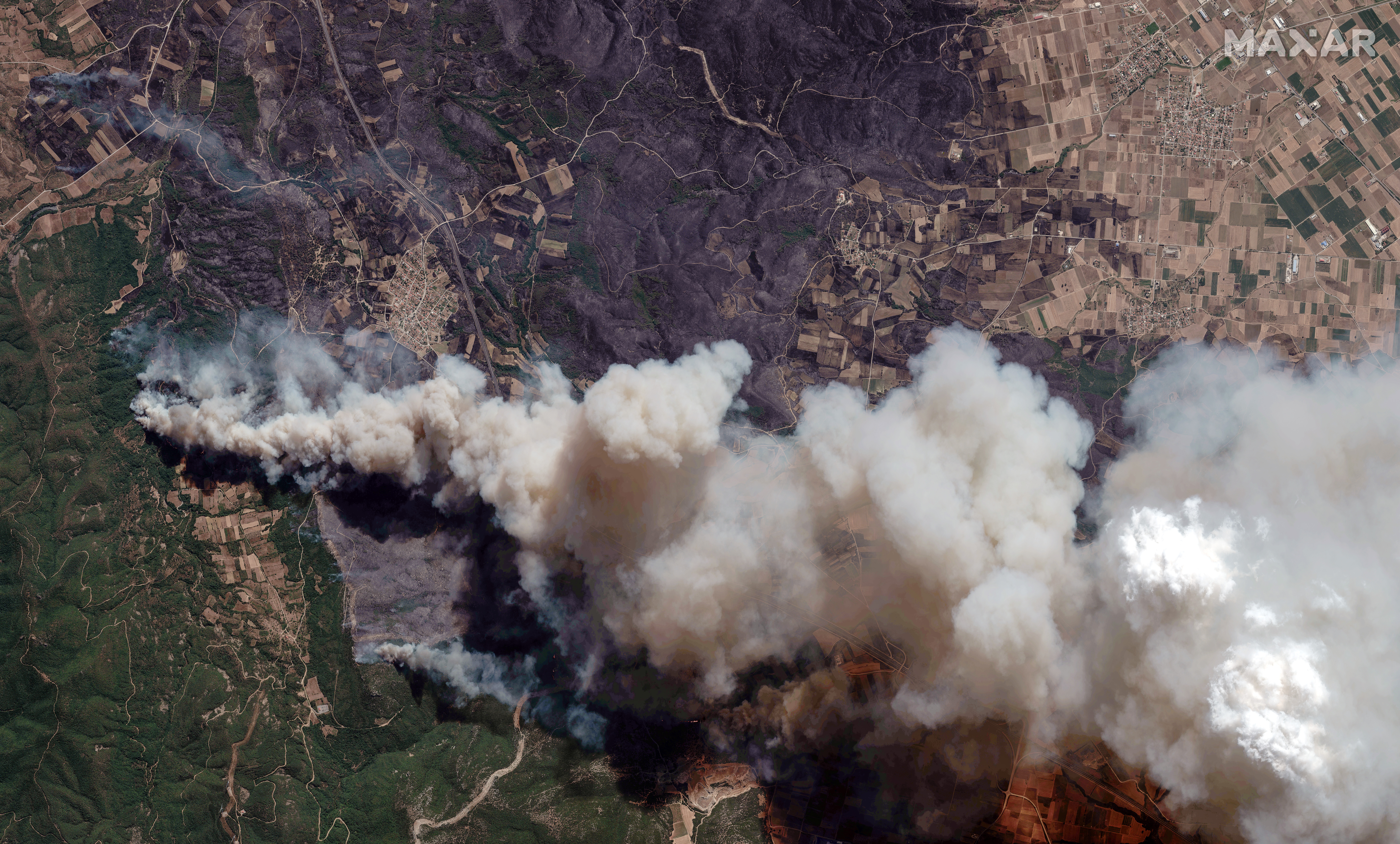 Rescuers in Greece find 18 burned bodies as wildfires spread