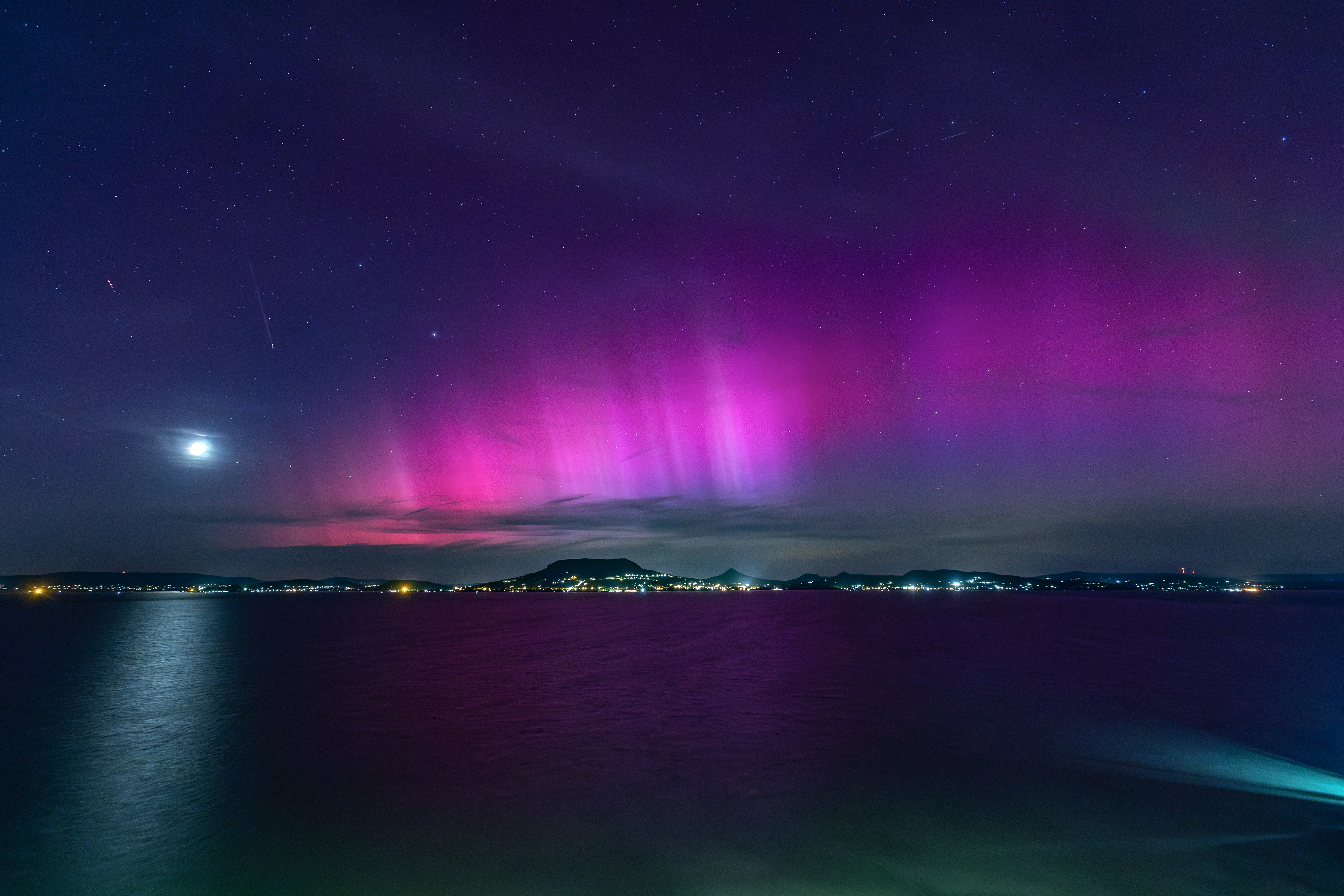 Solar storm brings dazzling aurora, threatens power grids