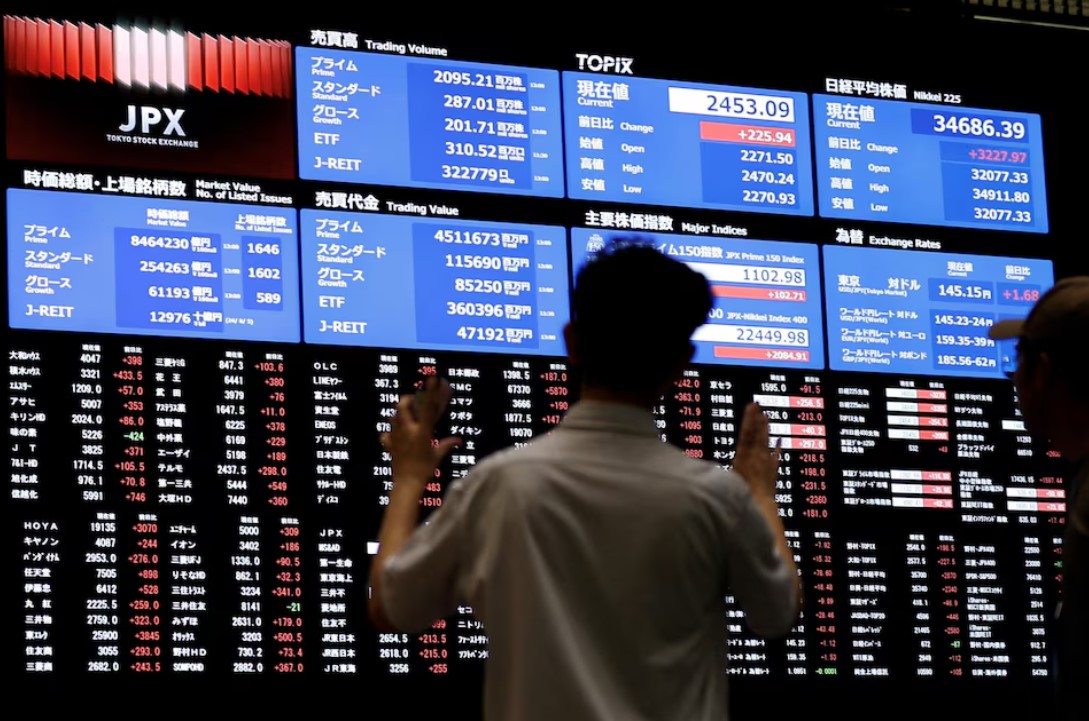 Stocks skid, dollar nears 3-week top as Trump announces auto tariffs