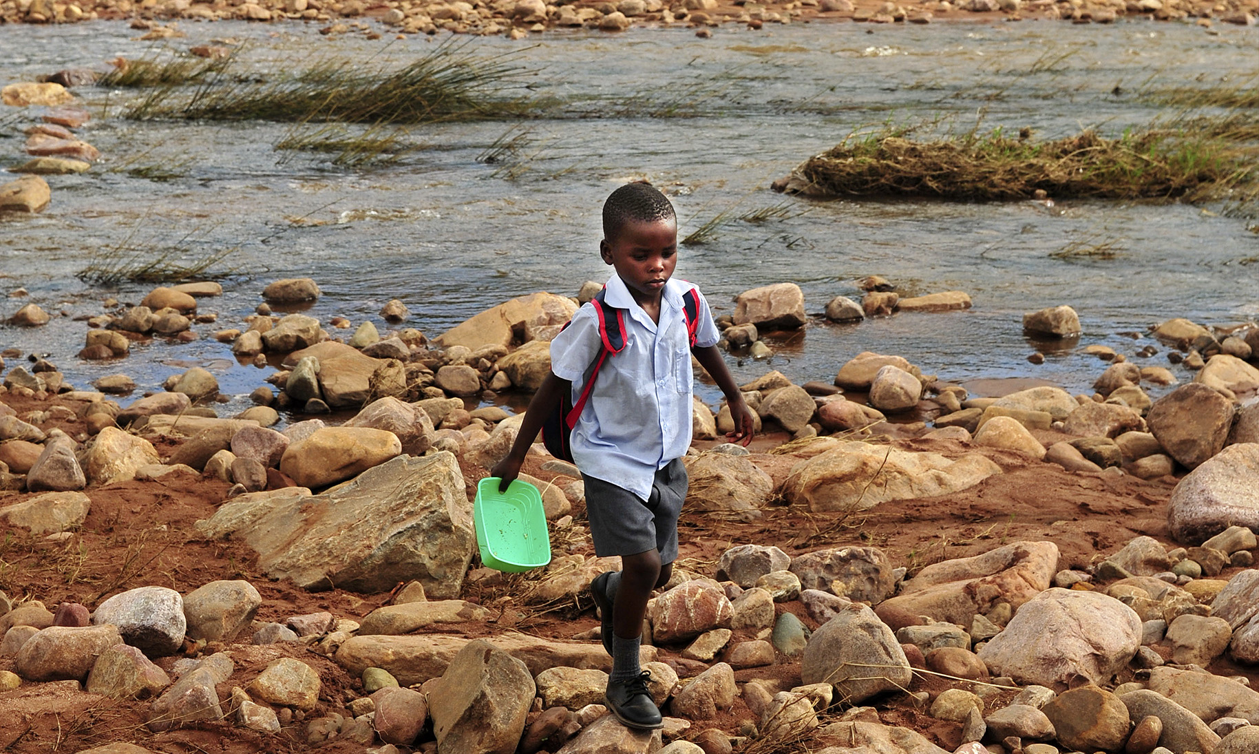 Across the (swept away) bridge, there is a school