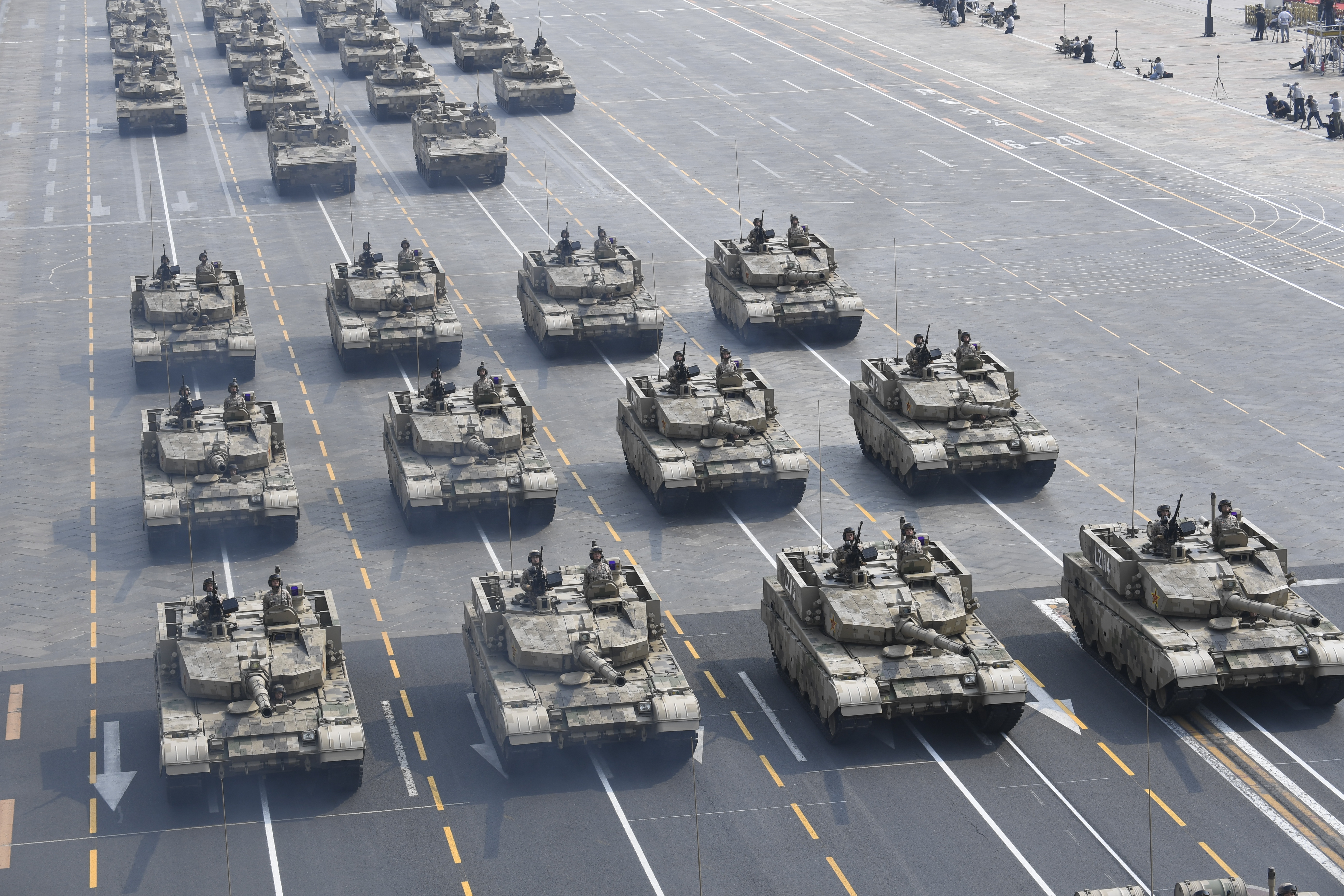 Split-screen moments between Hong Kong and Beijing rain on China’s triumphal parade