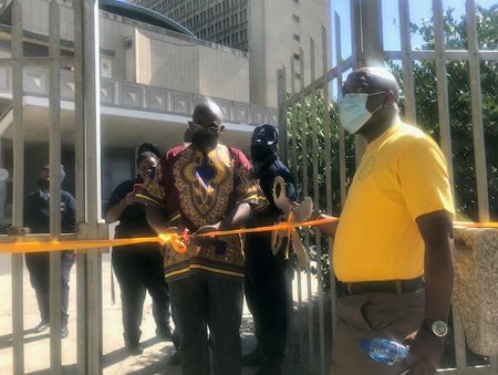 Refugee groups stage mock ceremony highlighting Home Affairs office closure