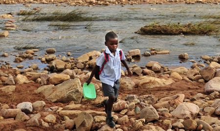 Across the (swept away) bridge, there is a school