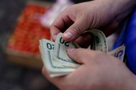 Dollar rides high on flagging euro and yuan